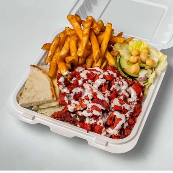 Halal Haven's chicken tikka platter with fries, salad, pita bread, and white sauce in a takeout container.